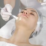 Woman receiving an anti-aging facial Reston VA with a soothing mask applied by an esthetician